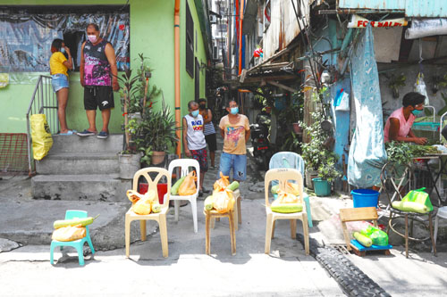 首都圏ケソン市の移動式コミュニティー・パントリーは5日、防疫措置で早急に食料を必要とする各家庭に向けて、接触を避けながら、無料で食料を提供した(AFP=時事)